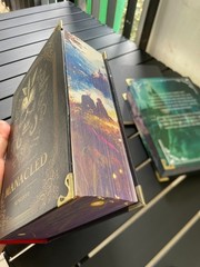 The limited edition hardcover novel Manacled (printed on three sides) collec