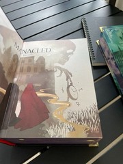 The limited edition hardcover novel Manacled (printed on three sides) collec